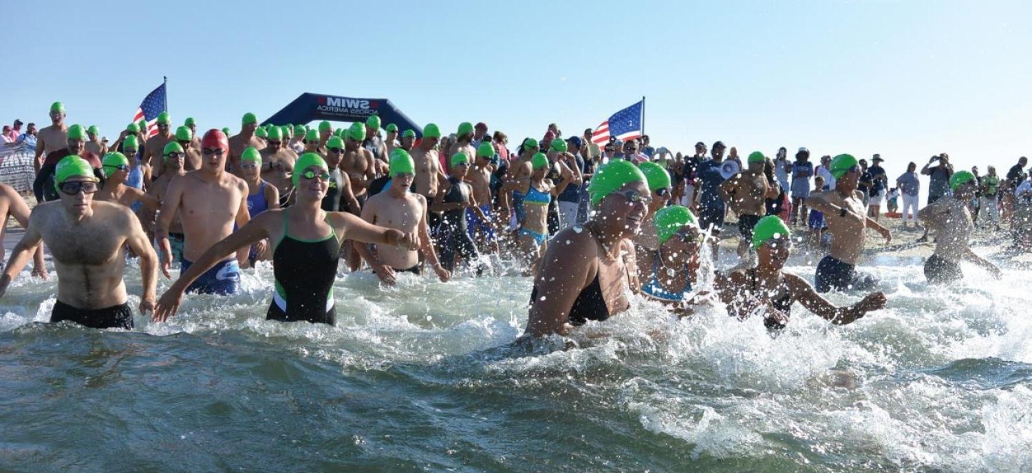 Swimmers running into the water 