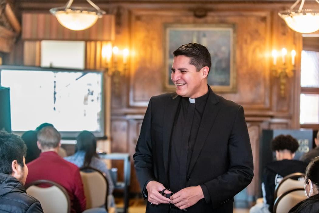 Messina College Dean Erick Berrelleza, S.J., speaks with accepted students and their families at an accepted students day event.