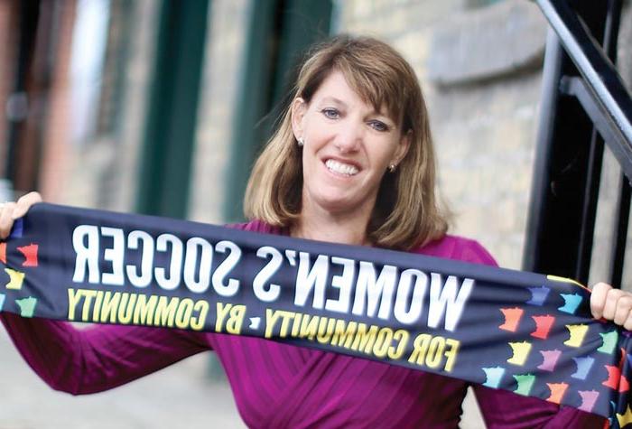 Andrea Yoch ’89 photographed holding soccer scarf